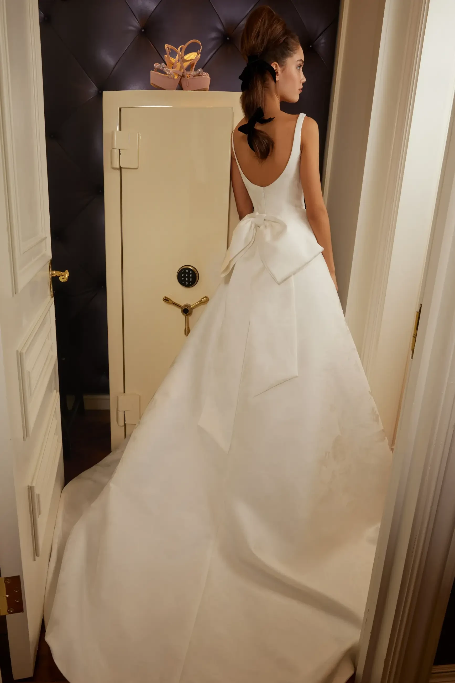 Model is wearing a jacquard ball gown with pockets and detachable bow by sareh nouri