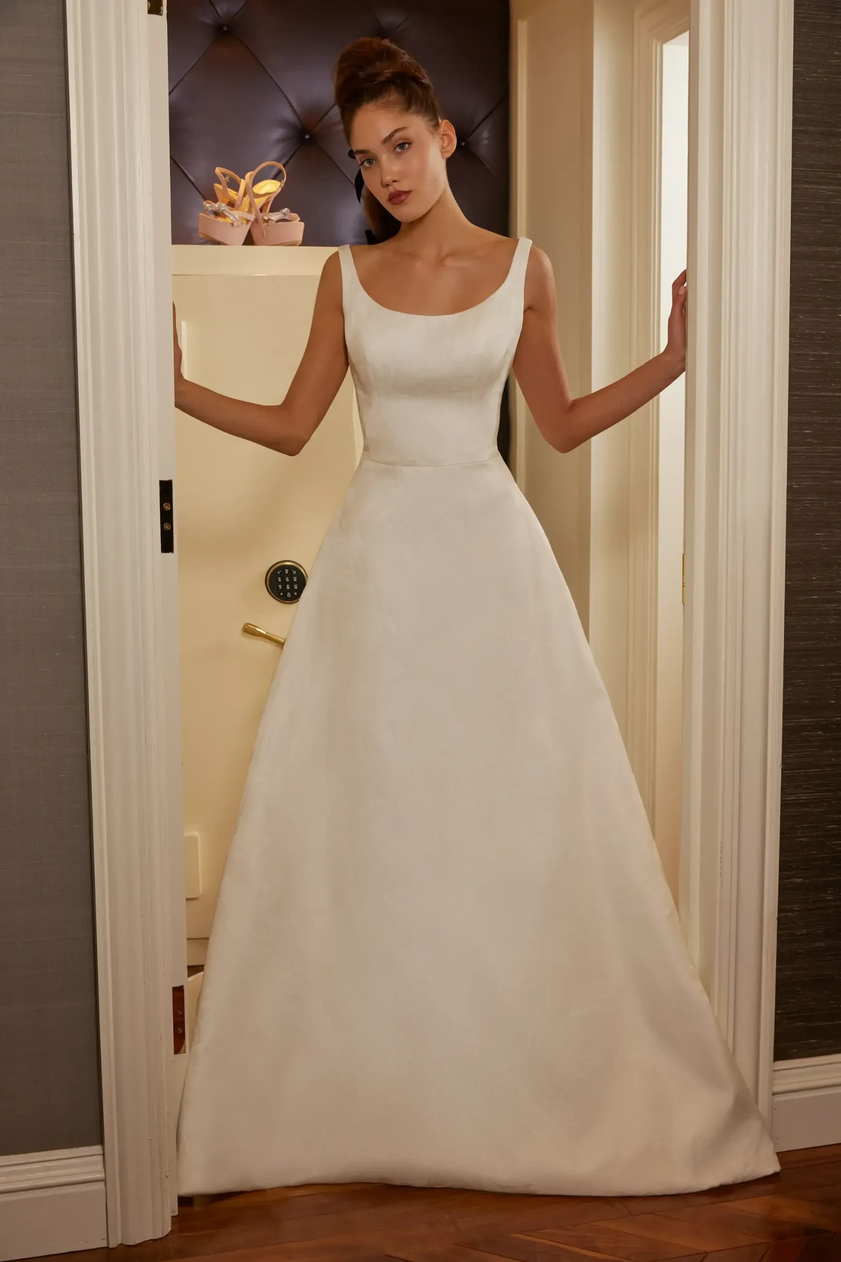 Model is wearing a jacquard ball gown with pockets and detachable bow by sareh nouri
