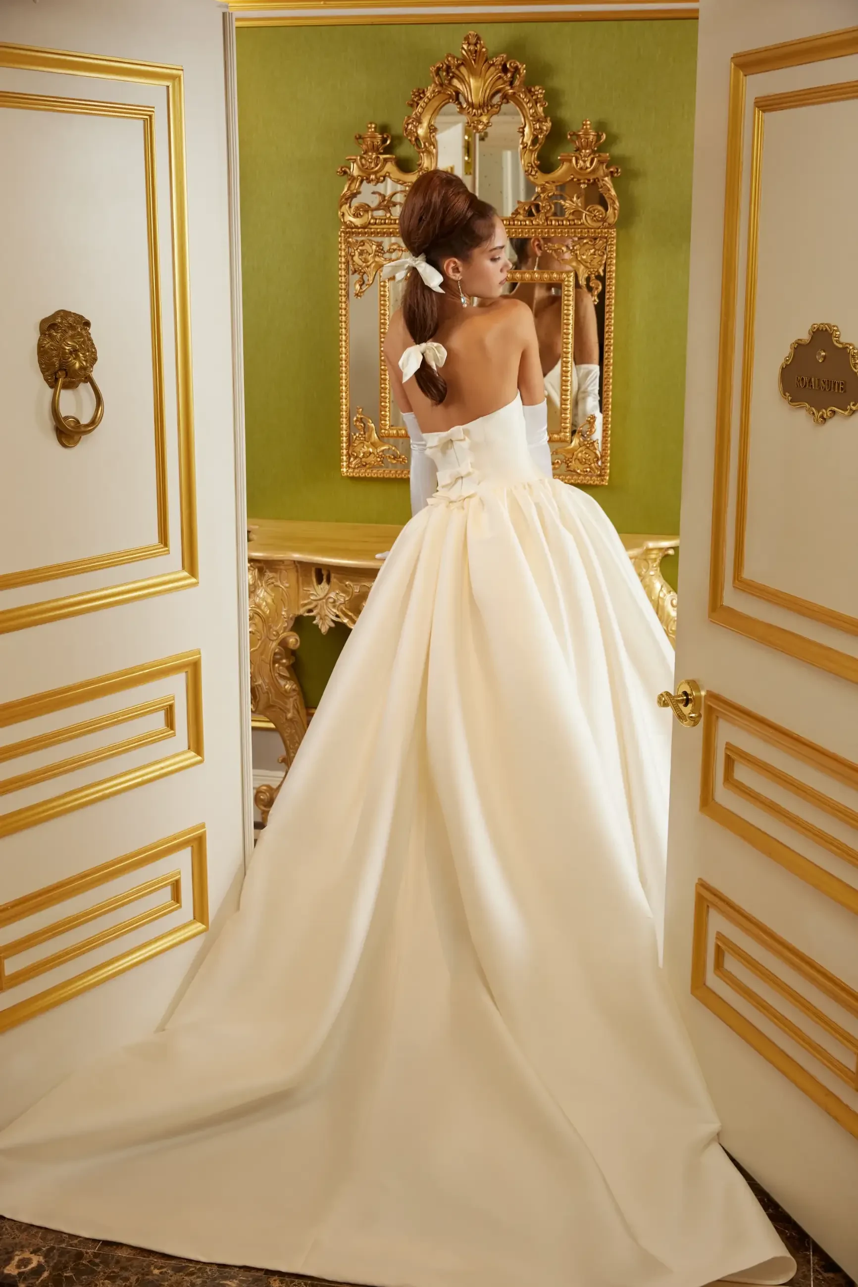 Model is wearing a mikado ball gown wedding dress with a basque waist by sareh nouri