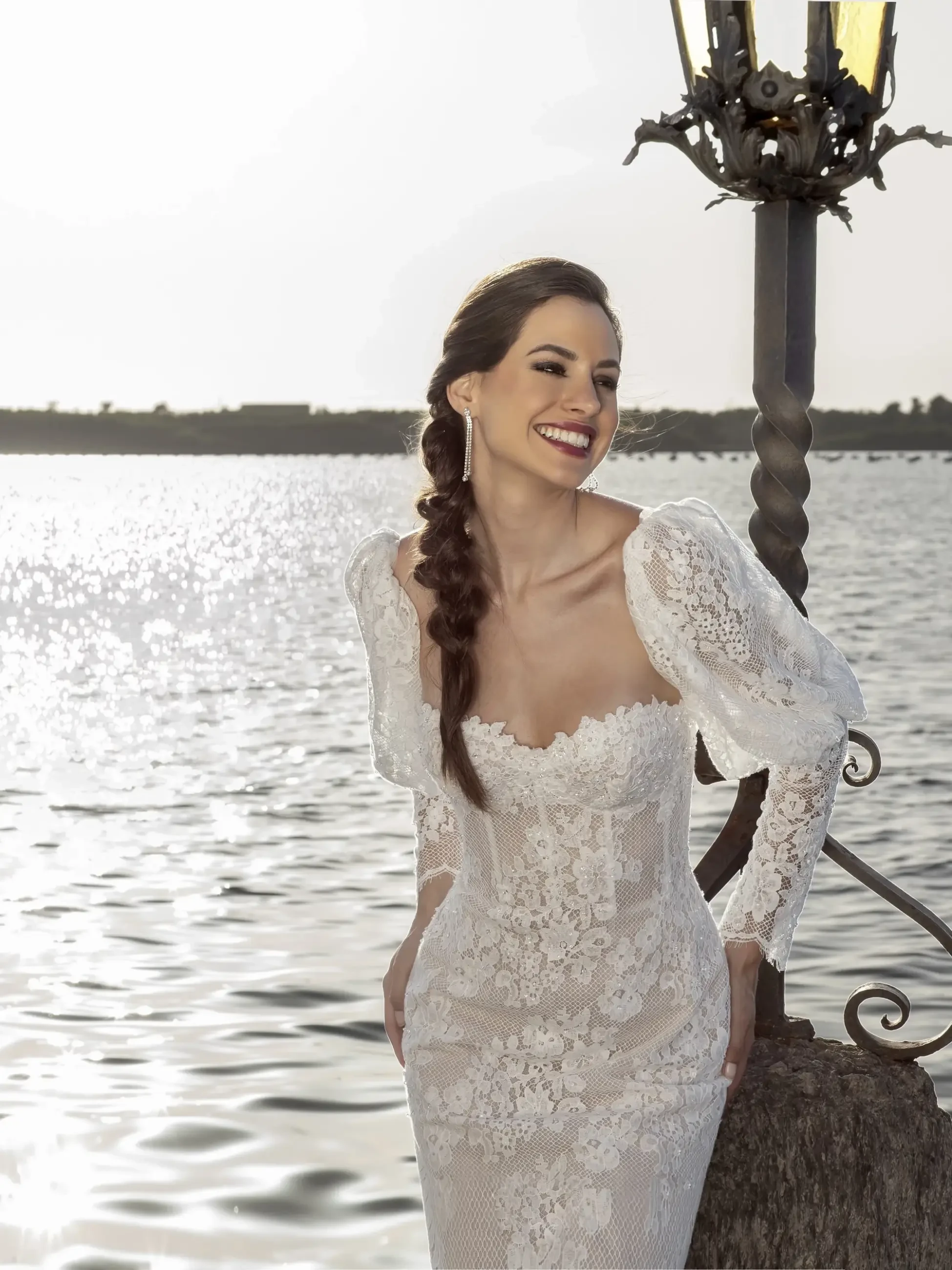 Model is wearing a strapless fit and flare allover lace bridal gown 